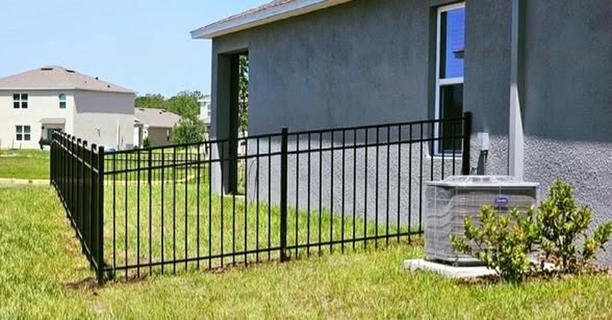 Black aluminum fence turning a corner on a St. Cloud property near the lake