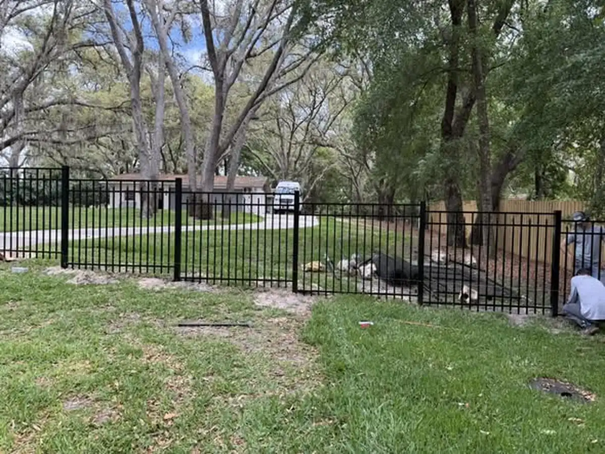 Aluminum fence stepping down a slope at a Winter Garden property
