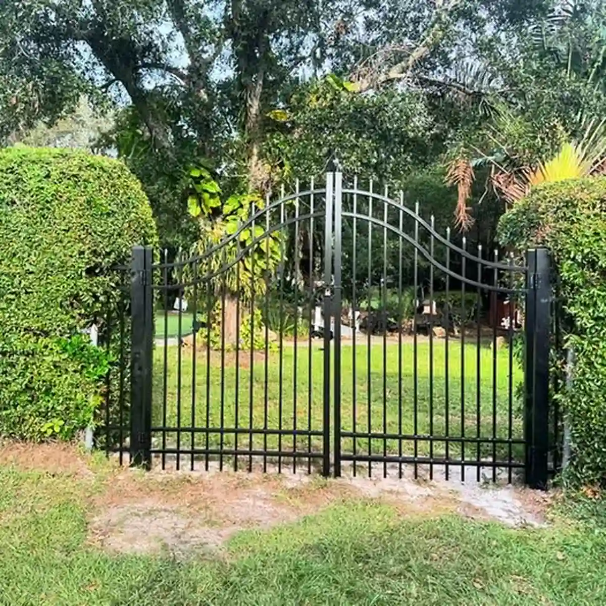 Aluminum garden gate set into a Winter Park fence line