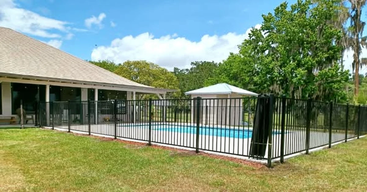 Black aluminum pool barrier fence around an Orlando ranch home pool