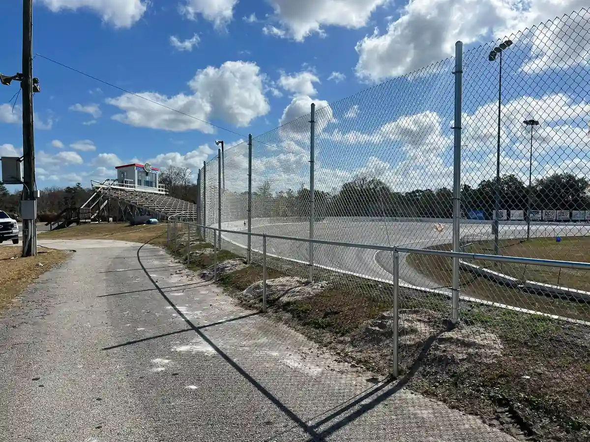 Tall chain link catch fence finished in front of speedway bleachers in Orlando