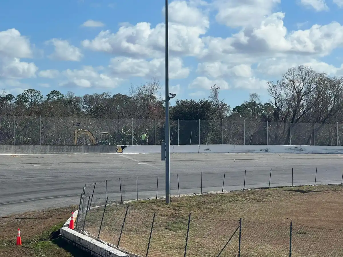 Straightline crew finishing the trackside chain link run at an Orlando speedway during installation