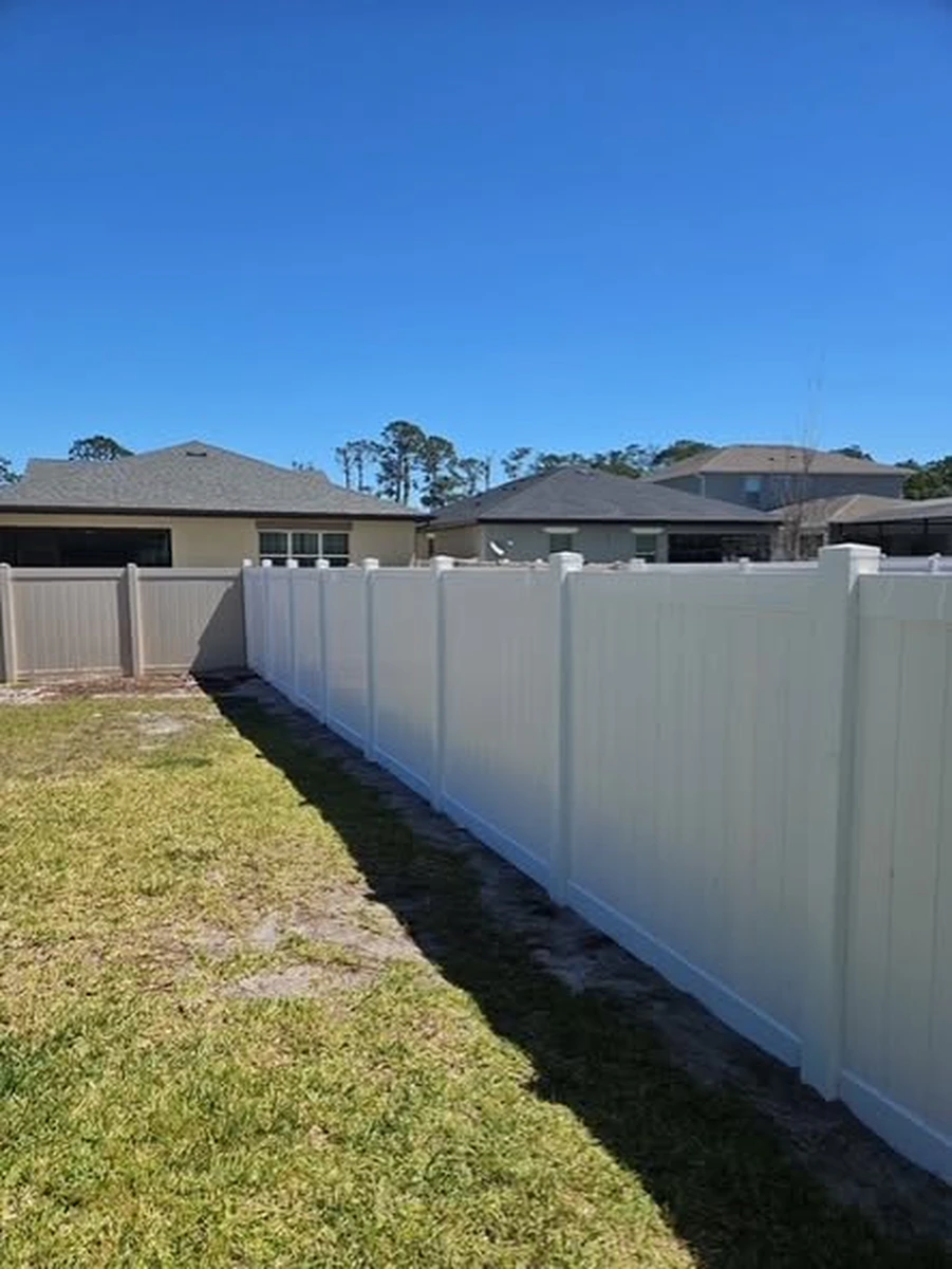 White vinyl privacy fence with a UV stable finish installed by Straightline Fence