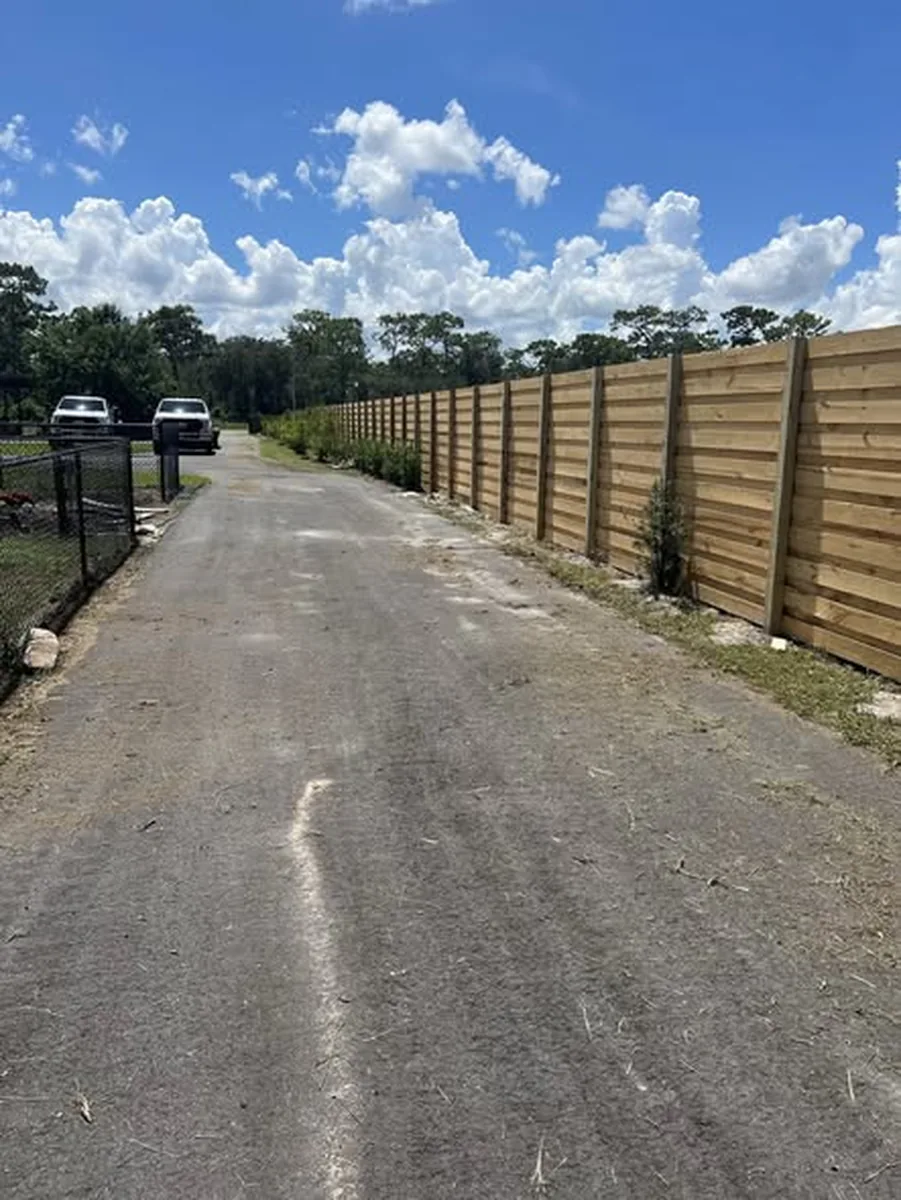 Completed commercial wood fence with planters seen from the left along a Melbourne frontage