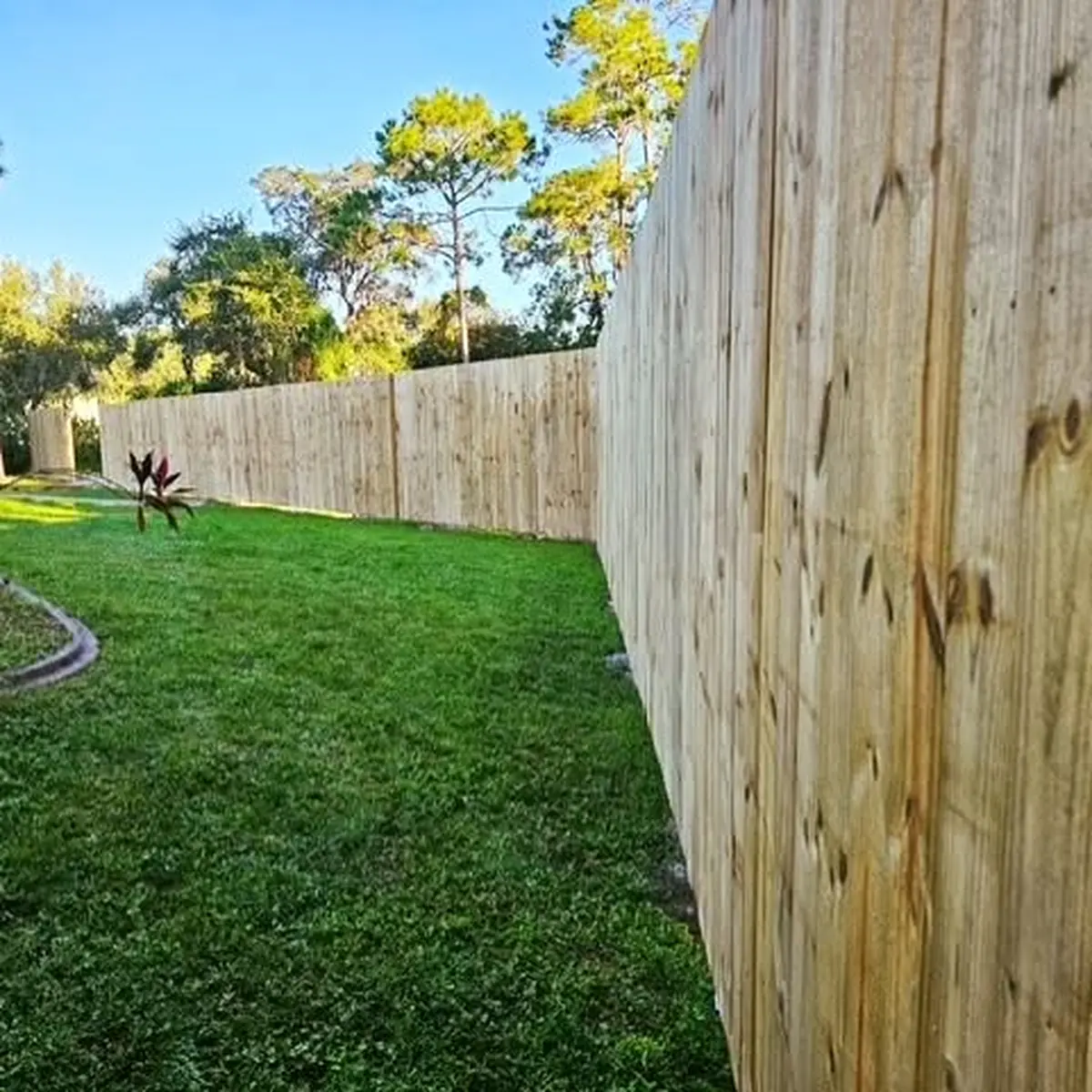 Tall wood privacy fence installed along a Sanford back yard